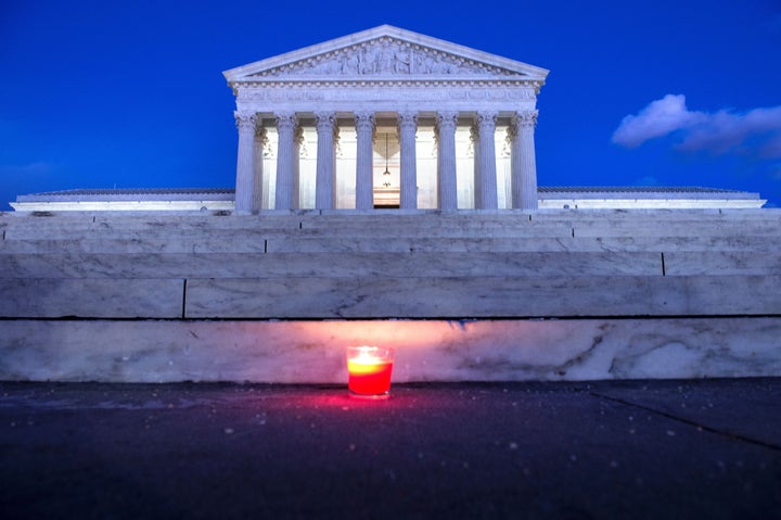 A candle is seen at the steps of the U.S. Supreme Court on Saturday following the announcement of the death of Justice Antonin Scalia