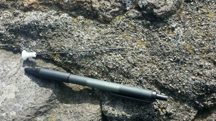 One of two blow darts that struck pedestrians on San Francisco's Golden Gate Bridge on Friday is seen next to a pen.