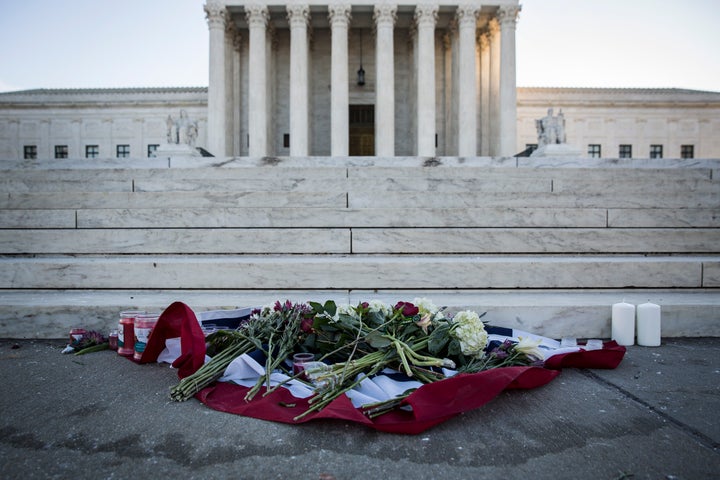 Flowers and candles sit at the bottom of the steps at the U.S. Supreme Court following the death of Justice Antonin Scalia.