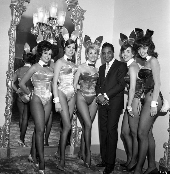 Rock and roll singer Jackie Wilson poses with a group of Playboy bunnies at a dinner for the Motion Picture Pioneers Association at the Playboy Club on November 19, 1962 in New York, New York.