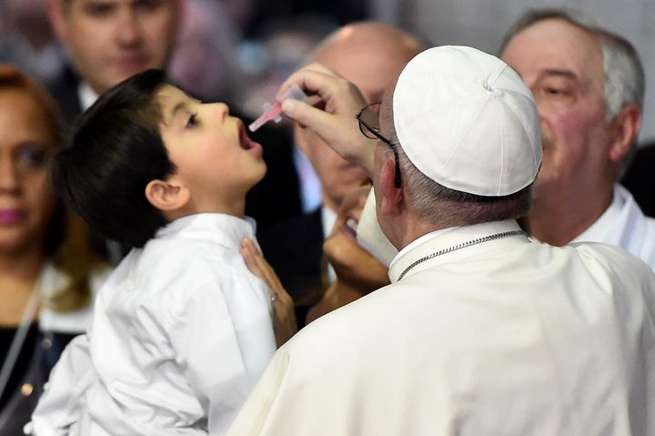 Pope Francis gives a medecine to a child during his visit to a children's hospital in Mexico on February 14, 2016.