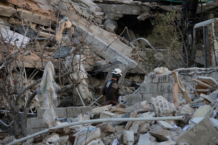 Rescue workers inspect the debris of a collapsed hospital in Maarat Numan. U.N. Secretary-General Ban Ki-moon said the attack