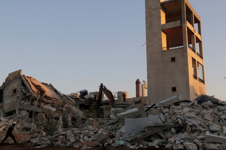 Rescue workers inspect the debris of a Doctors Without Borders hospital in Maarat Numan. Russian-backed Syrian troops have intensified their push toward the rebel stronghold of Aleppo.