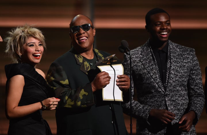 Musician Stevie Wonder (C) and Pentatonix present the Song of the Year on stage during the 58th Annual Grammy music Awards in