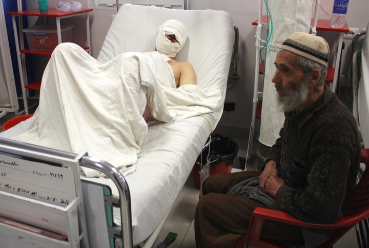 Burhanuddin, a 35-year-old farmer and father of four, lays in a bed at Kabul's Emergency Hospital after surviving a rocket attack in Kunduz, northern Afghanistan.