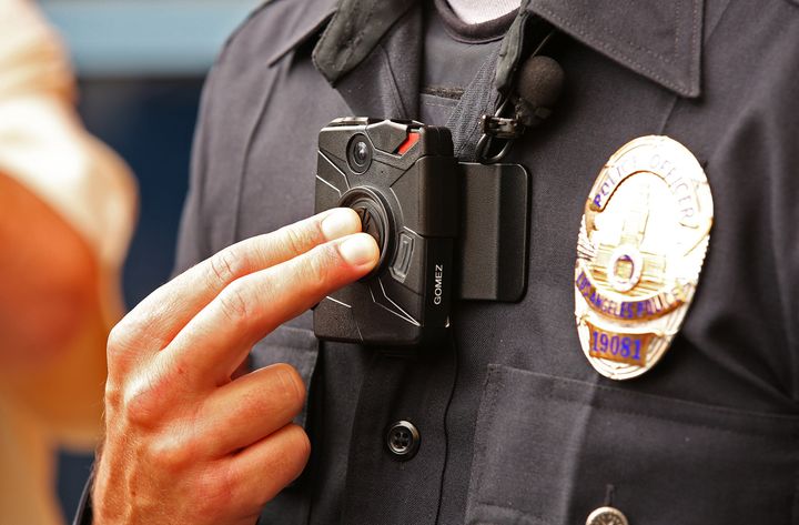 Los Angeles Police Officer Jim Stover demonstrates how an officer turns on the new LAPD body camera during a press conference in September 2015. Body camera laws across the country are taking footage from public to private.