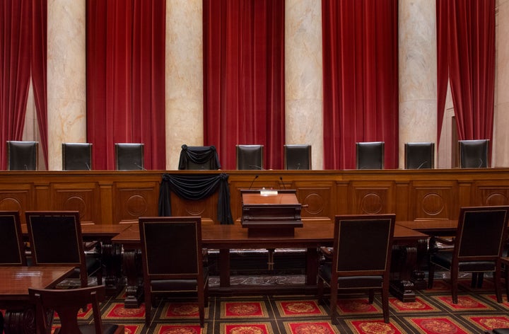 Justice Antonin Scalia's bench chair and the bench in front of his seat are draped in black to commemorate his death on Feb. 13, 2016.