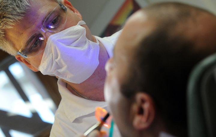A dental patient is treated in Hungary, where thousands of Western Europeans travel every year for such care.