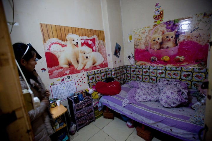 A woman prepares to leave for work at her apartment inside a Chinese air defense bunker on the outskirts of Beijing, China, on Friday, Feb. 11, 2011.