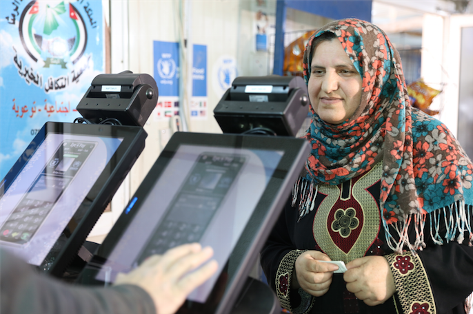 A Syrian refugee has her eyes scanned to pay for groceries at King Abdullah Park refugee camp in northern Jordan.