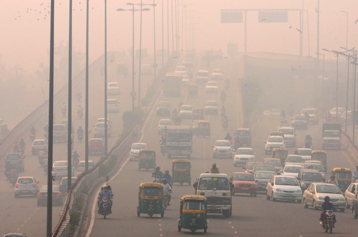 People commute amid smog on Nov. 3, 2015, in New Delhi. Such pollution is largely responsible for record-high temperatures seen over the past four months, scientists say.