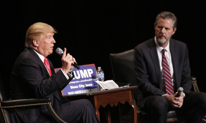 Jerry Falwell Jr. sits with Donald Trump during a campaign campaign event in January. Falwell, who has endorsed Trump, on Thursday appeared to draw a dividing line between Christian teachings and political leadership.