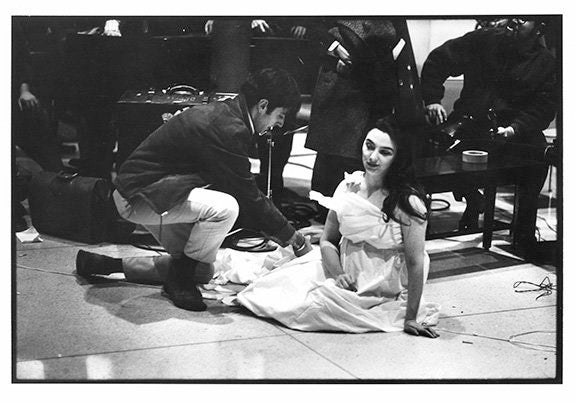 Peter Moore. Charlotte Moorman performs Yoko Ono’s <em>Cut Piece</em>, New York University, New York City, December 16, 1967. Photograph © Barbara Moore/Licensed by VAGA, NY.