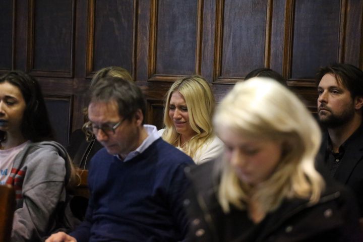 Kesha (center in white) cries as she learns she will not be released from her record label contract in Manhattan Supreme Court on Friday, February 19, 2016. A judge said she would not allow Kesha to leave her record label.