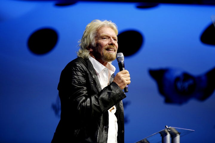 Sir Richard Branson, about to christen the new Virgin Galactic SpaceShipTwo at its roll out.