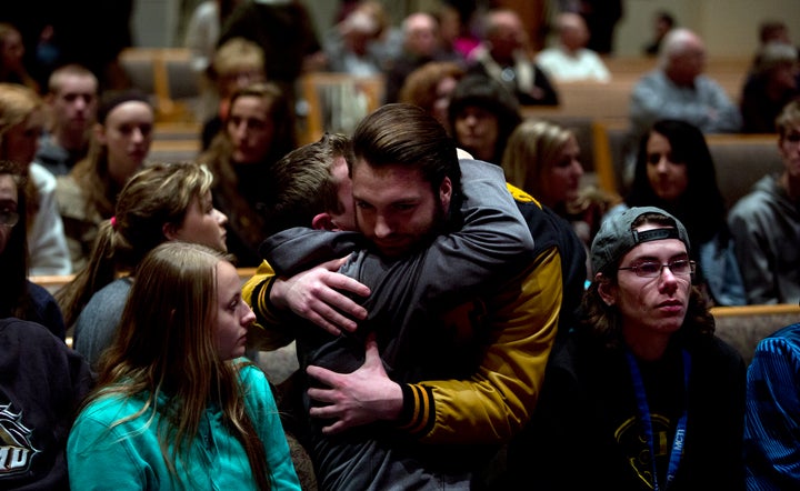 People gather and pray at Center Point Church in Kalamazoo following the shooting.