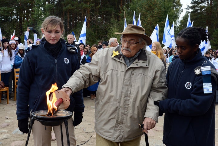 Willenberg lights a candle at a monument on the site of the Treblinka death camp in October 2013.