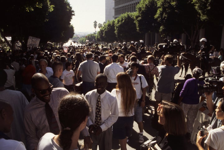 A crowd convenes outside the courthouse as a "not guilty" verdict is read.