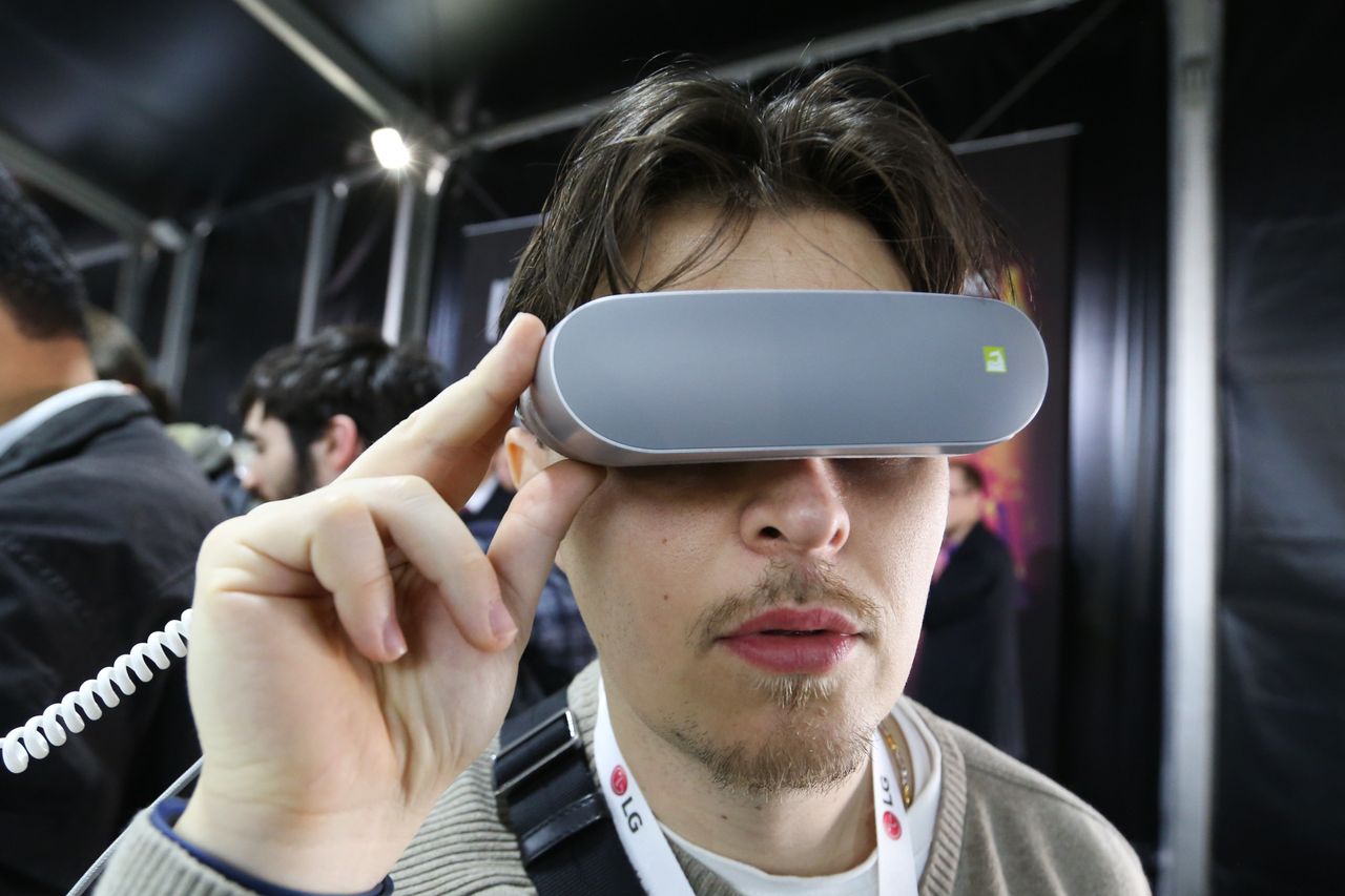 A conference attendee tries a set of LG 360 VR goggles.