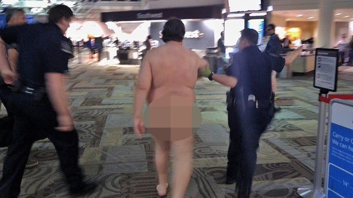 The eye-catching traveler was led away by officers inside the airport.