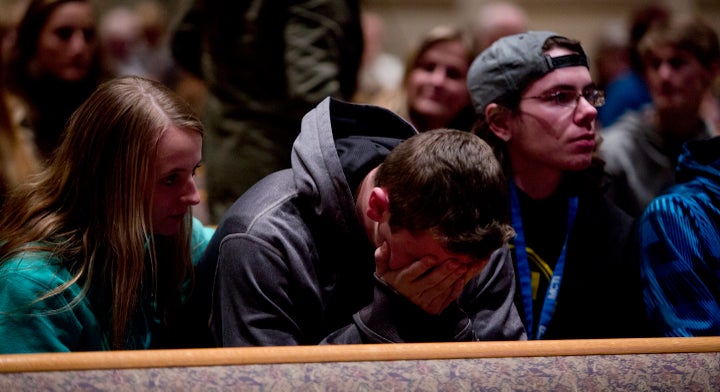 People gather and pray at Center Point Church in Kalamazoo, Michigan, on Sunday. The shooting there was not covered on the ma