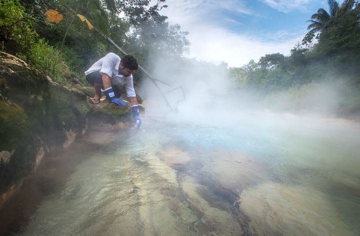 Andrés Ruzo collects a water sample from Peru's boiling river. 