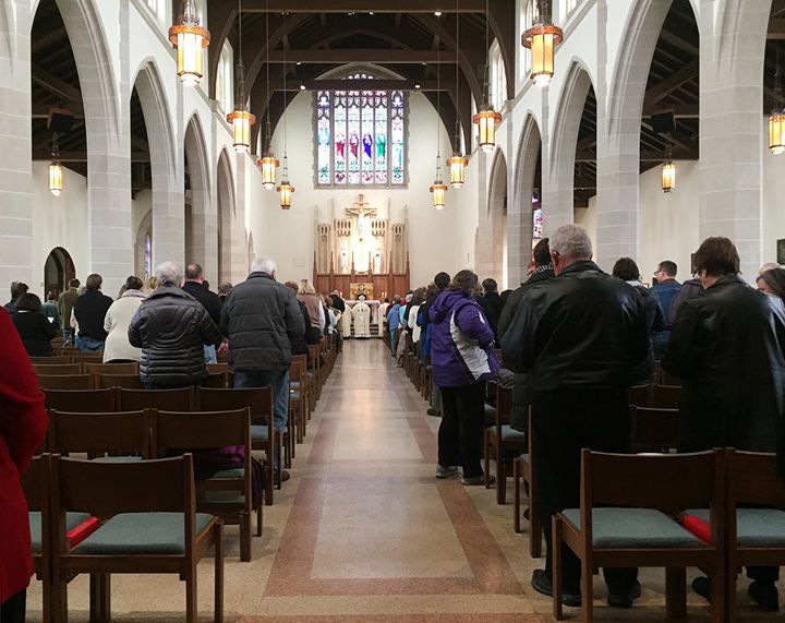Community members gather at St. Augustine Catholic church on Monday afternoon for a special mass dedicated to the victims of Saturday's deadly shooting.