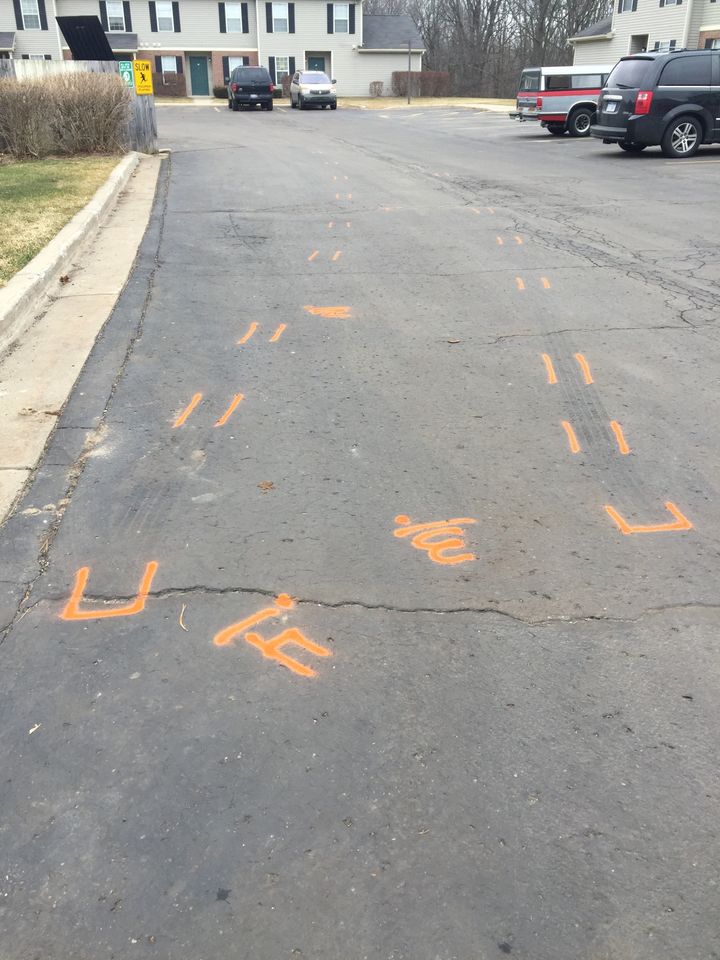 Paint marks getaway tracks and shell casings from the Feb. 20 shooting at the Meadows townhome complex in Kalamazoo. The complex was the first of three locations hit by alleged shooter Jason B. Dalton. 