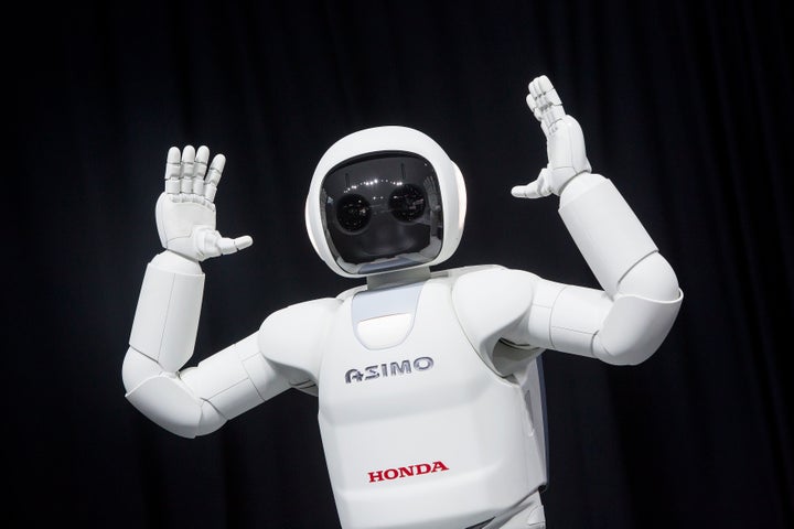 Honda's ASIMO robot on display in 2014. The robot is designed to recognize people and understand certain actions, like raising a hand to ask a question.