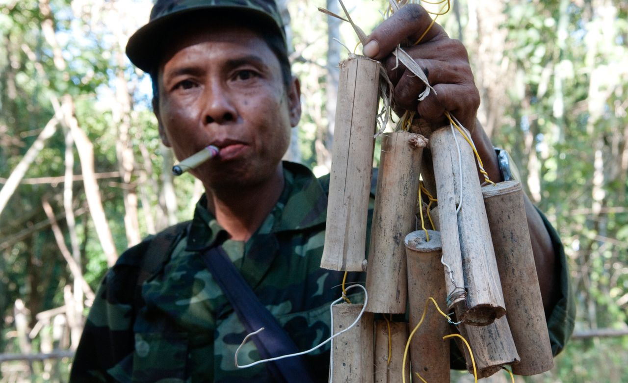A soldier from the Karen National Liberation Army, one of Myanmar's armed ethnic groups, holds up a collection of homemade landmines in January 2011. Myanmar ranks first in Asia, and third in the world for the highest number of landmine casualties.