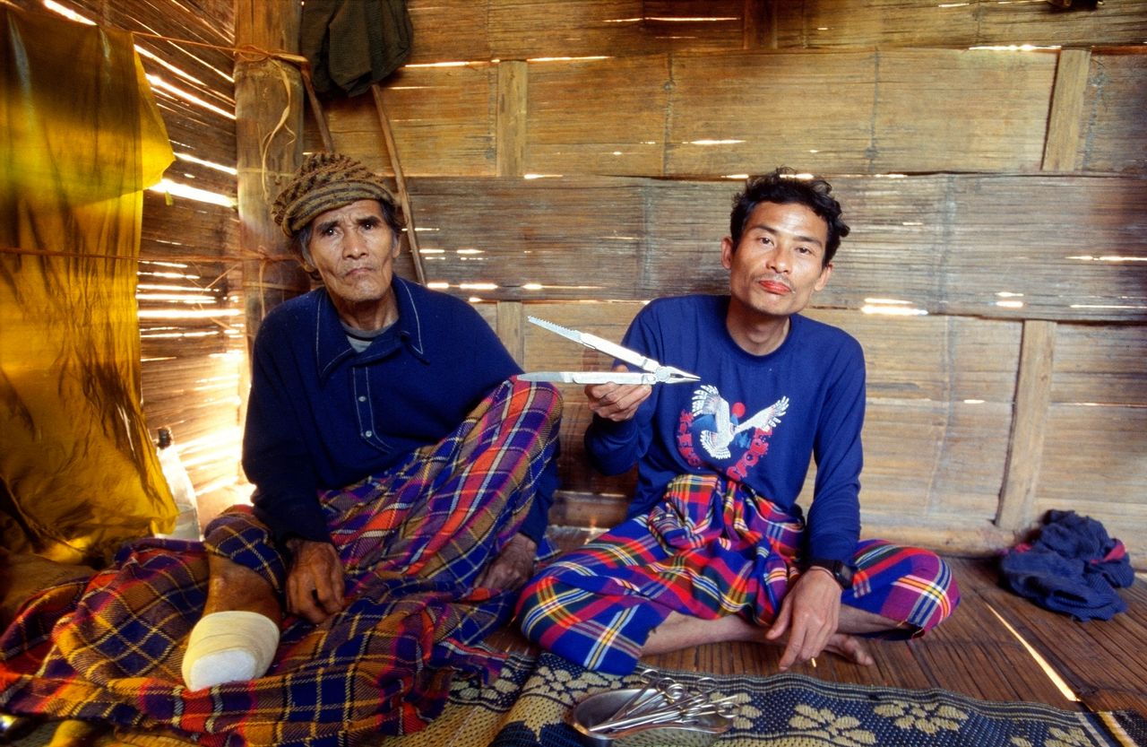 Saw Tu La, a 75-year-old Karen villager, left, lost his lower left leg in November 2005 when he stepped on a landmine planted by the Tatmadaw in his village. His leg was amputated by medic Hsa Gaw, right, who operated on him with a Leatherman-like knife (pictured).