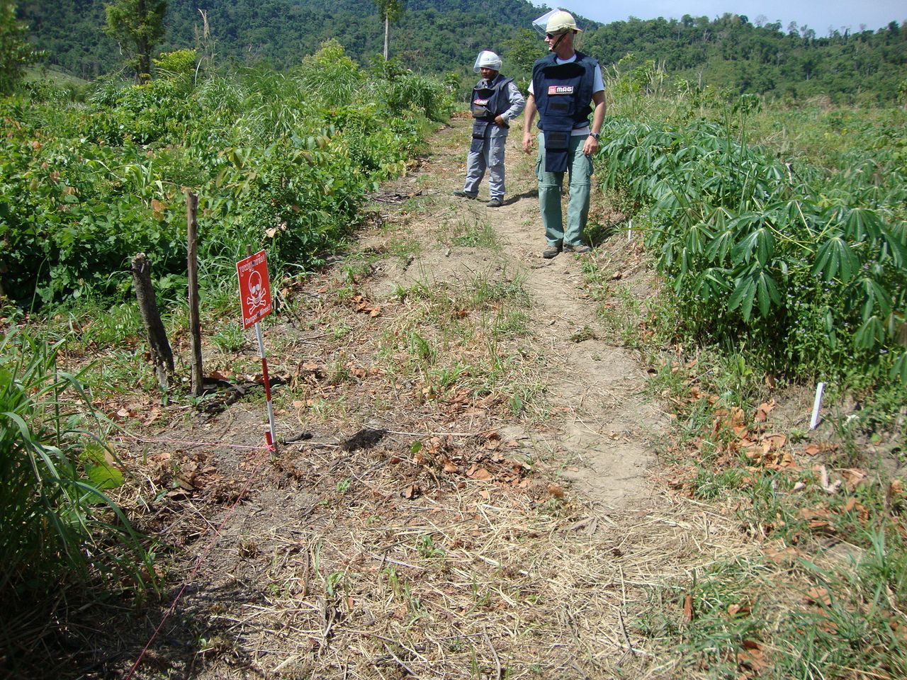 Detective Tony Langer, right, carrying out mine clearance in Battambang, Cambodia.