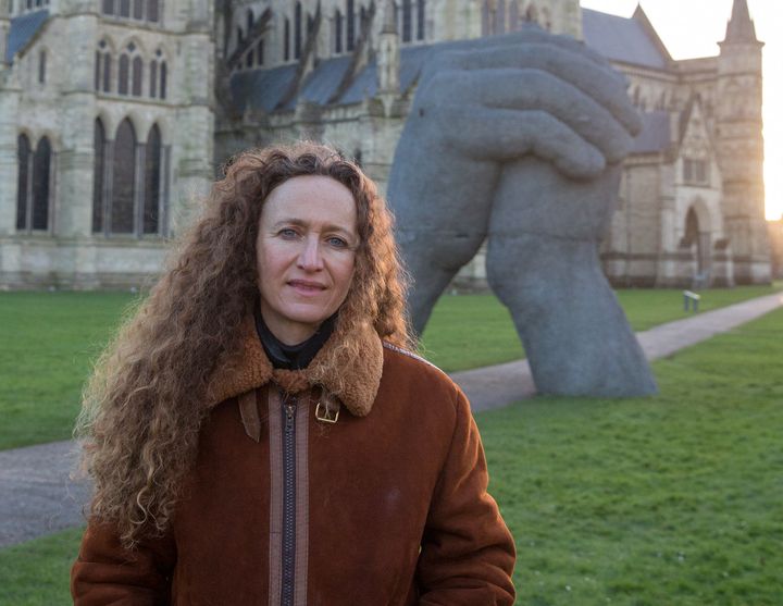 Sculptor Sophie Ryder poses in front of "The Kiss" outside Salisbury Cathedral earlier this month.