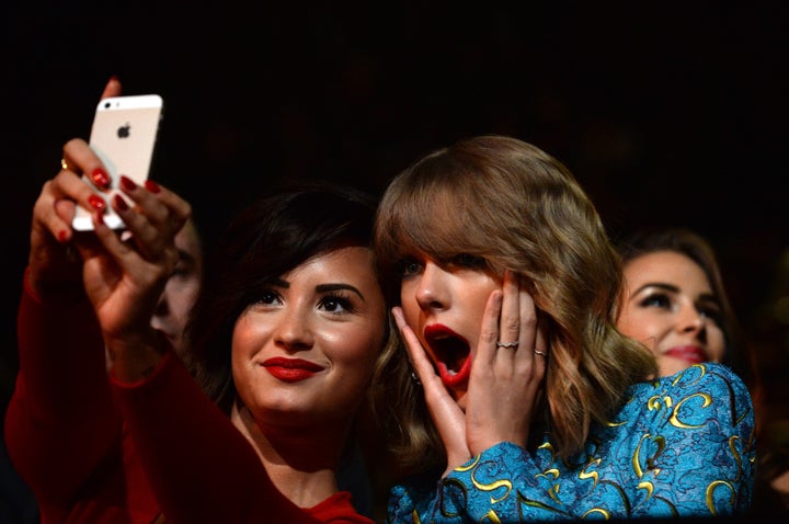 Recording artists Demi Lovato (L) and Taylor Swift take a selfie at the 2014 MTV Video Music Awards at The Forum on August 24, 2014 in Inglewood, California.