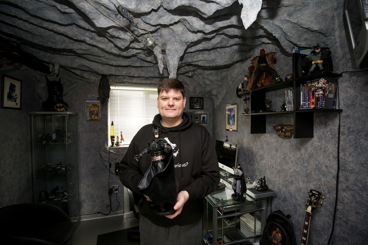 Darren Wilson, 46, has turned his spare bedroom into a replica of the bat cave as a place to store his Dark Knight memorabilia.