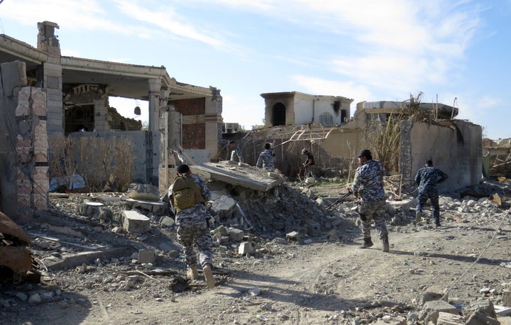 Iraqi troops remove bombs from houses and streets in Ramadi, Iraq, after retaking the city from the self-described Islamic St