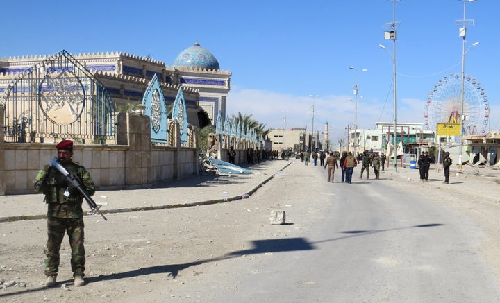 A member of the Iraqi security forces guards a street in Ramadi after the country retook the city from Islamic State mil