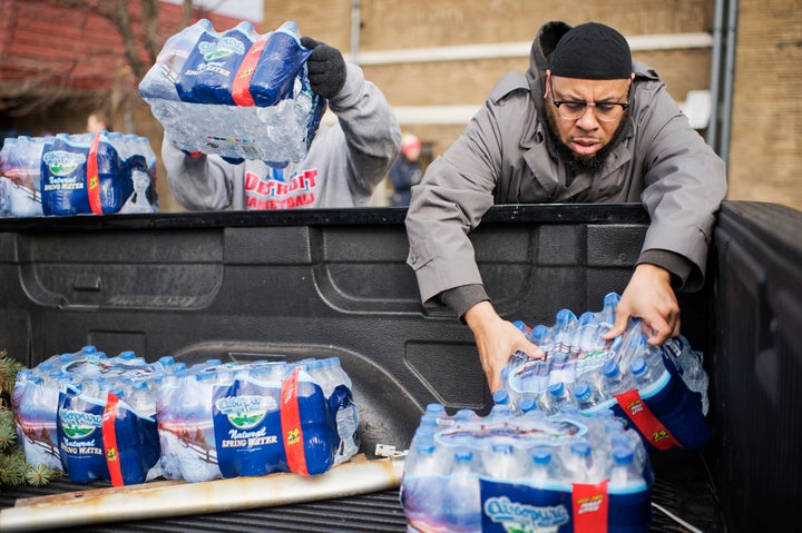 Volunteers load bottled water in a truck at the the Sylvester Broome Center in Flint, Michigan, Feb. 22, 2016.