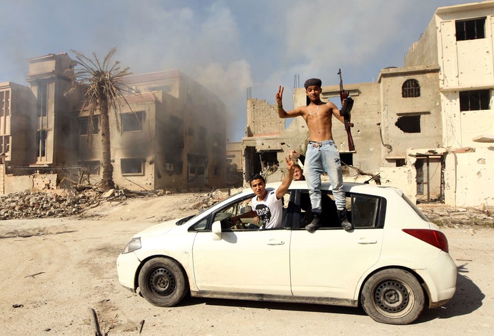 Fighters loyal to Libya's internationally recognized government celebrate as they come close to seizing the center of the eastern coastal city of Benghazi on Feb. 23 after a string of gains against Islamist militias, including the Islamic State group.