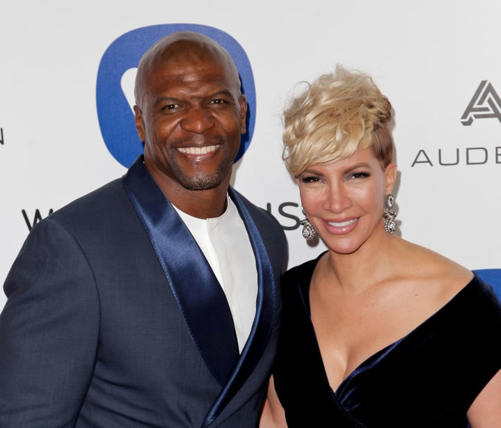 Terry Crews and his wife Rebecca King-Crews pose as they arrive to attend the Warner Music After Party, in Hollywood, California, on February 16, 2016.