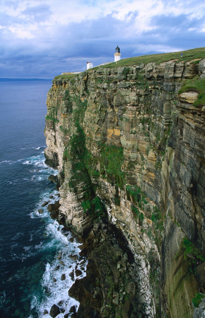 Dunnet Head lighthouse on a cliff overlooking Pentland Firth.