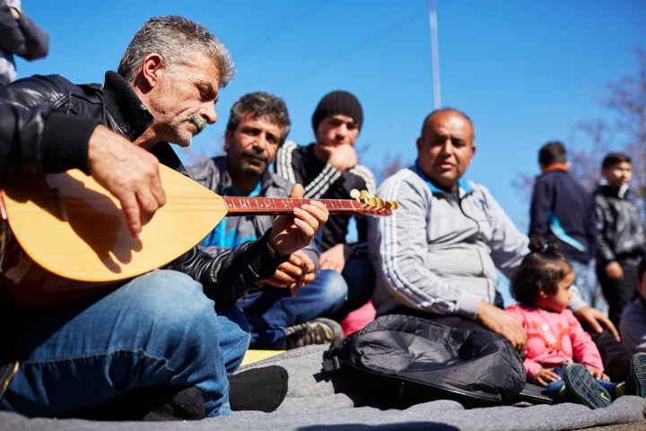 Syrians have been arriving in Greece since the 1990s to look for work. Many left during the economic crisis, only to return, this time as refugees. Here, Syrian Kurds play music as they wait in a Greek border camp.