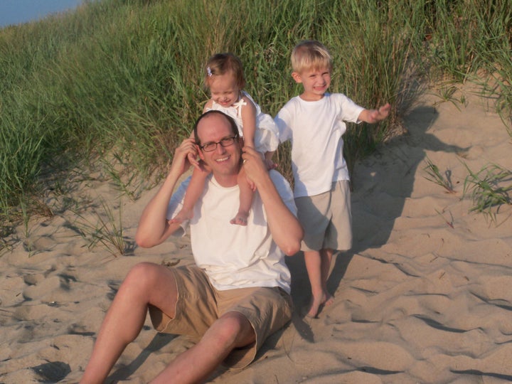 Brian playing on the beach with Marika and Isaiah.