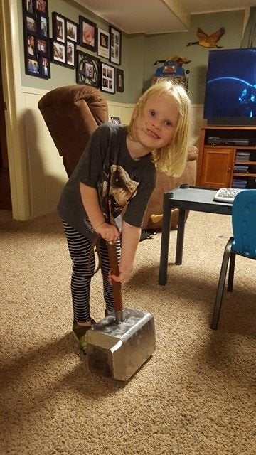 Autumn trying to pick up Thor’s axe, which was part of Brock’s Thor costume.