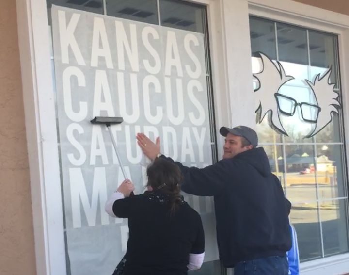 Campaign volunteers put up a sign in the window of Bernie Sanders' Shawnee, Kansas, field office on Feb. 24, 2016.
