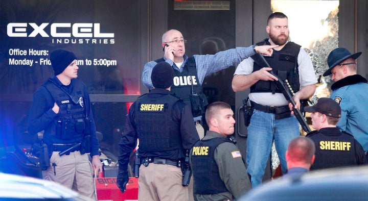 Police guard the front door of Excel Industries in Hesston, Kansas, where a gunman opened fire on Thursday.