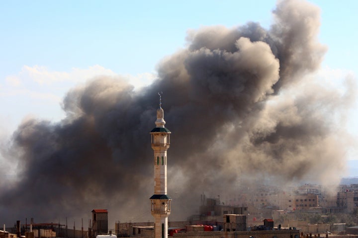 Fighting raged on several fronts on Friday ahead of the truce. Here, smoke rises after airstrikes in the Eastern Ghouta region of Damascus on Friday.