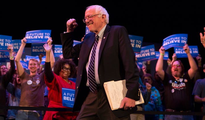 Bernie Sanders gives the crowd a fist as he enters the "Get Out The Vote" rally and concert at Township Auditorium in Columbia, South Carolina.