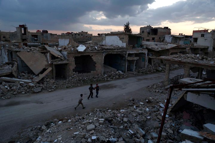 The truce brought a partial calm on Saturday, the first time in five years of war that a ceasefire has lasted for more than a few hours. Above, children walk through the rebel-held town of Douma on Saturday.