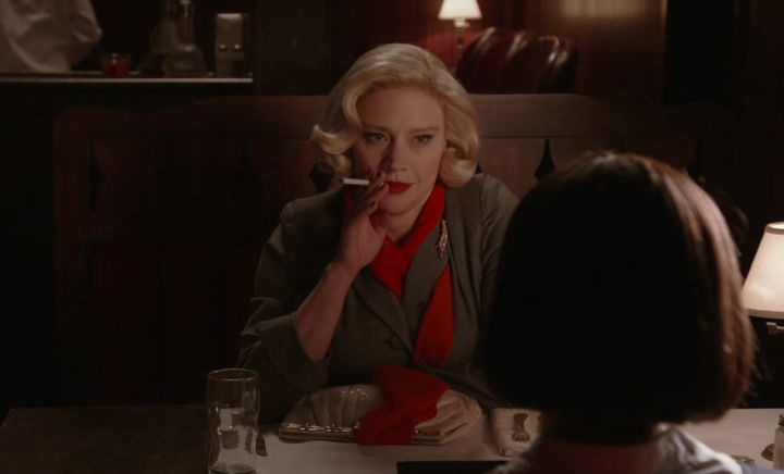 Kate McKinnon as Carol in "Carol," trying to seduce Rooney Mara's Therese. 